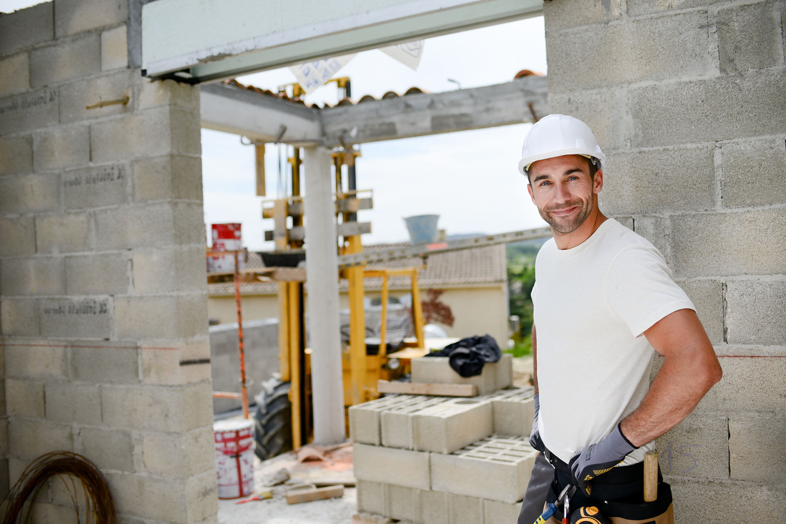 portrait of handsome construction worker on building industry construction site